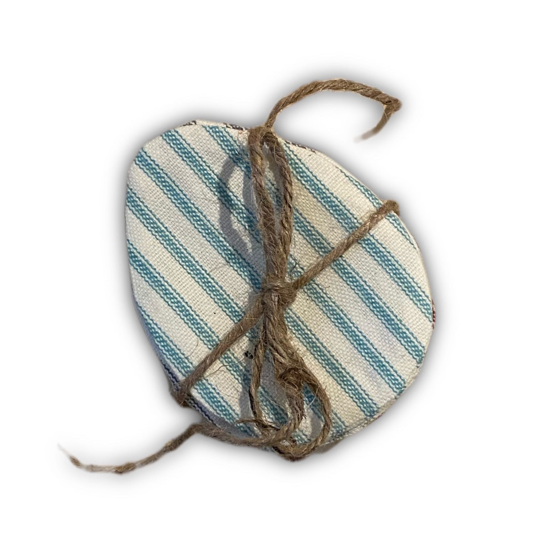 A bundle of striped fabric easter eggs tied together with twine, on white background.